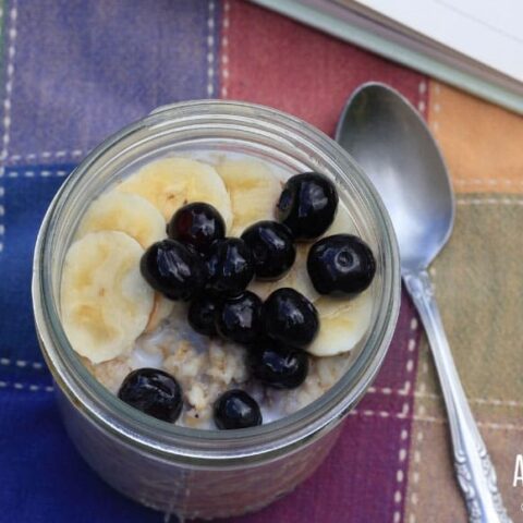 oatmeal in a jar with sliced bananas and blueberries