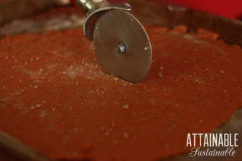 pizza cutter cutting gluten free cracker dough