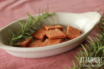 gluten free cracker recipe finished and in an oblong white dish with a sprig of rosemary
