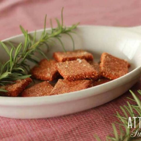 gluten free cracker recipe finished and in an oblong white dish with a sprig of rosemary