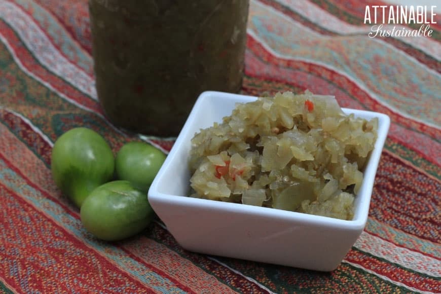 green tomato relish in a square white dish on a red striped background