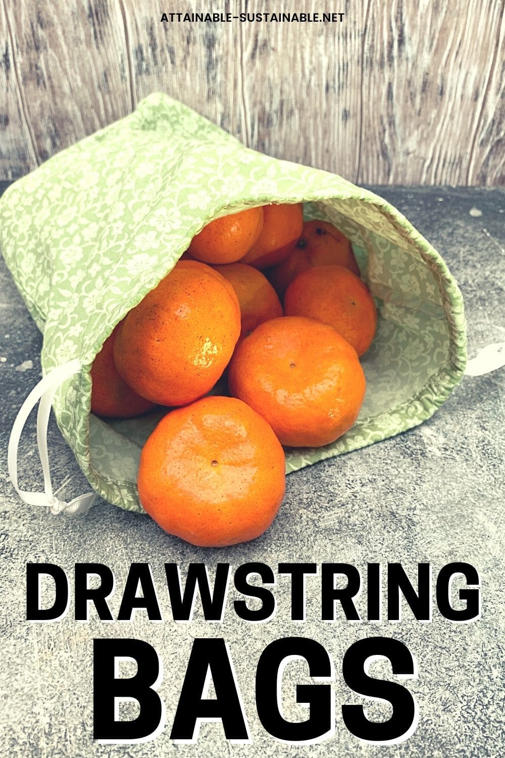 bright orange tangerines spilling out of a green drawstring bag.