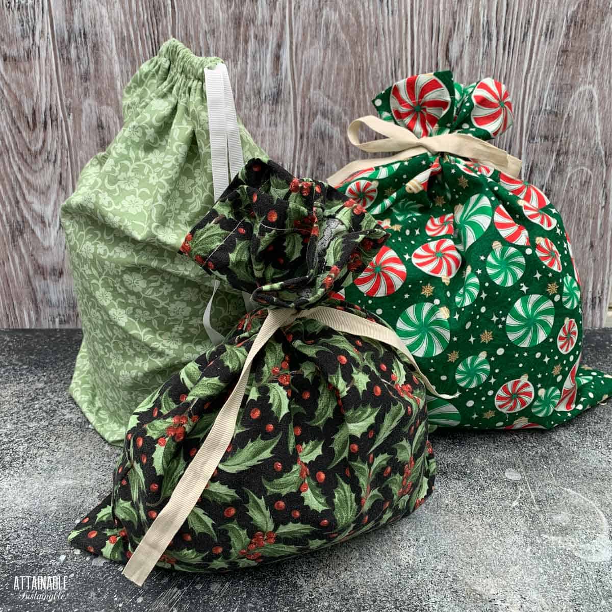 3 fabric gift bags tied with ribbon.