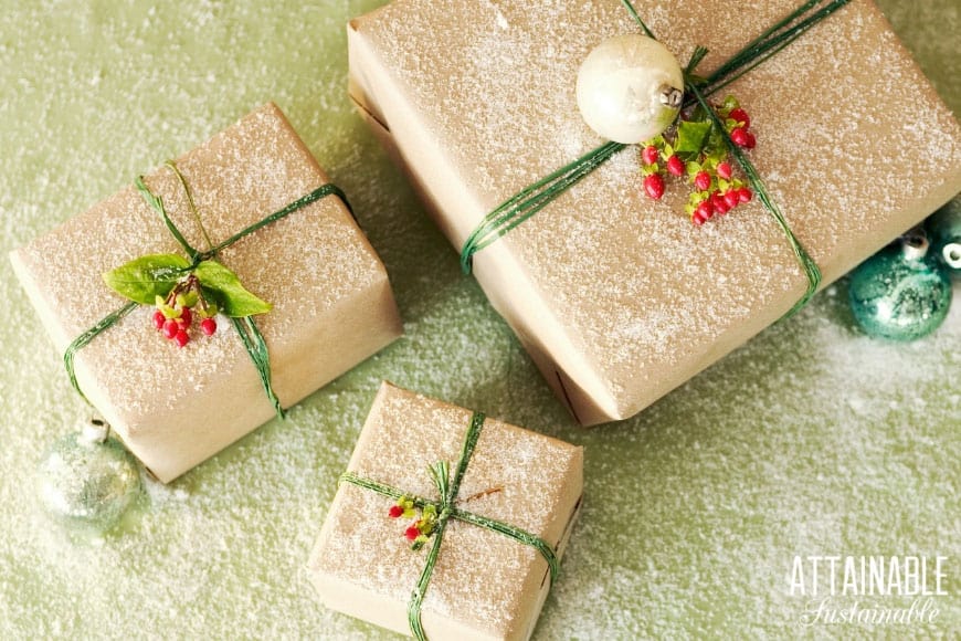 3 square gifts wrapped in brown paper with green ribbon