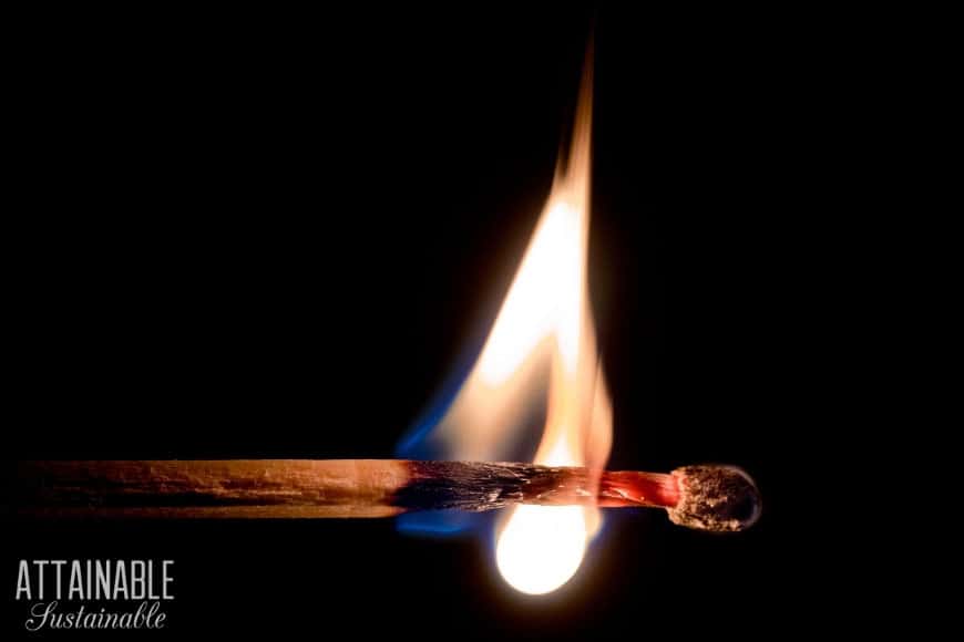 Whether natural disaster or economic collapse, emergency preparedness is key to survival. Practical preppers can be ready for both without the panic button. wooden match with flame, against black backdrop