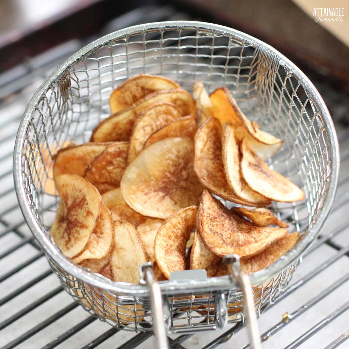 potato chips in a deep fryer basket.