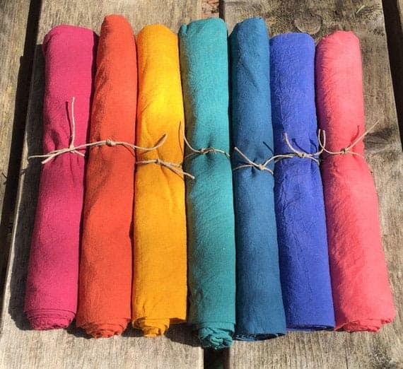 rainbow colored play silks on a wooden deck - perfect gifts for kids