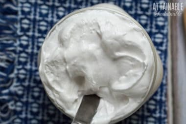 homemade marshmallow fluff in a jar from above, blue and white cloth behind
