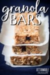 stack of three homemade granola bars, parchment paper between.