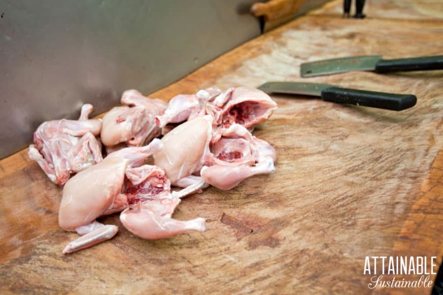 butchered chickens on a wooden table with knives