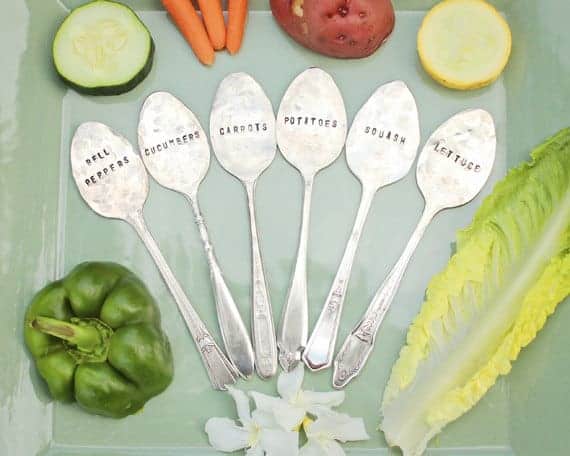 silver spoons pounded flat and stamped with vegetable names for plant markers