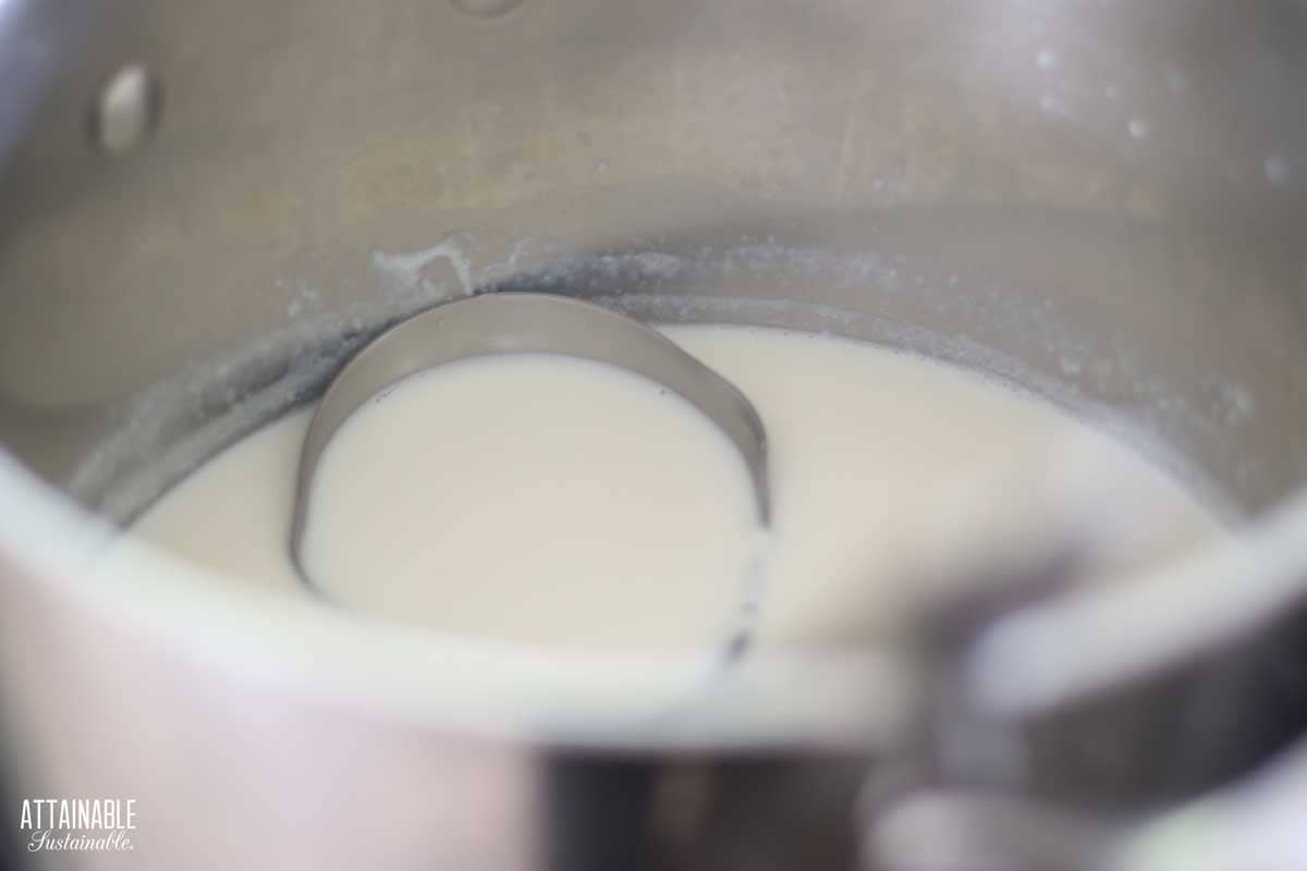 milk in a pot with a ladle.