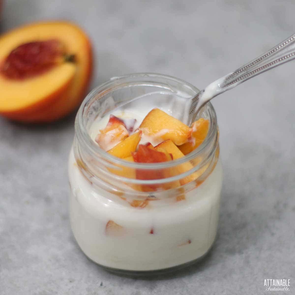 jar of vanilla yogurt with peaches mixed in.