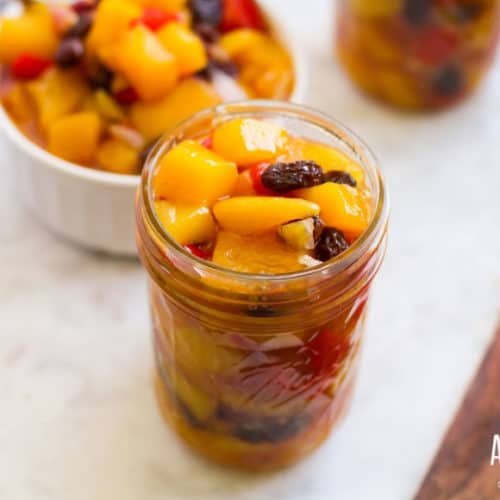 White bowl full of mango chutney, plus a canning jar full