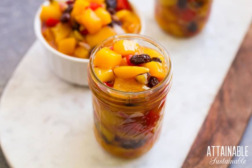 White bowl full of mango chutney, plus a canning jar full