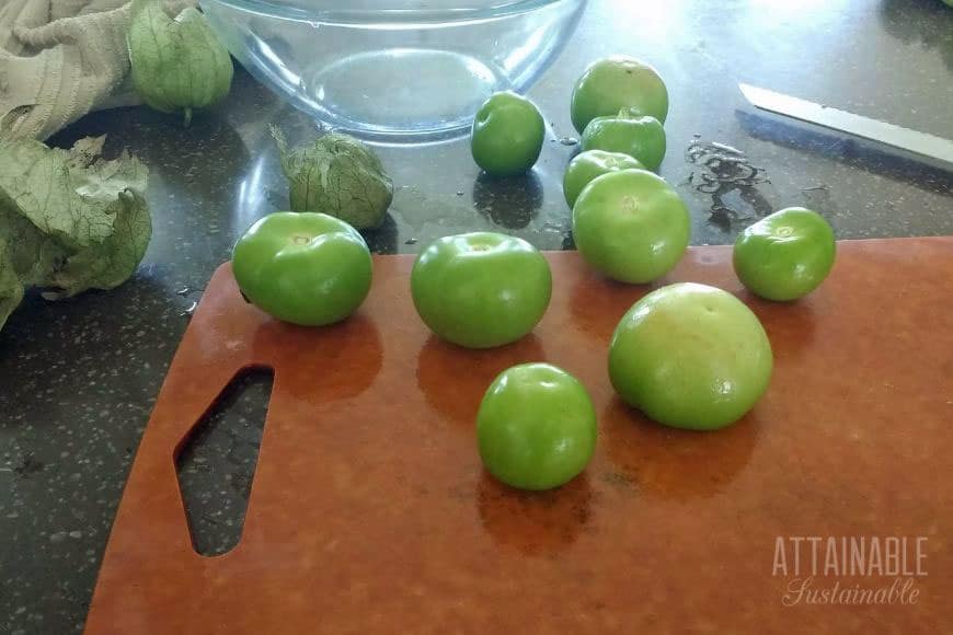 fresh tomatillos on a cutting board to make salsa verde