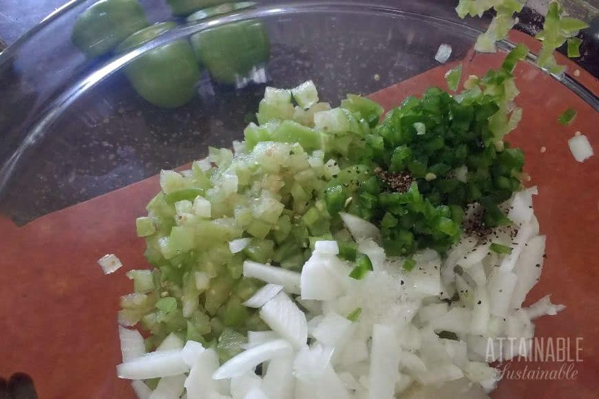 chopped tomatillo, onion, hot pepper in a glass bowl
