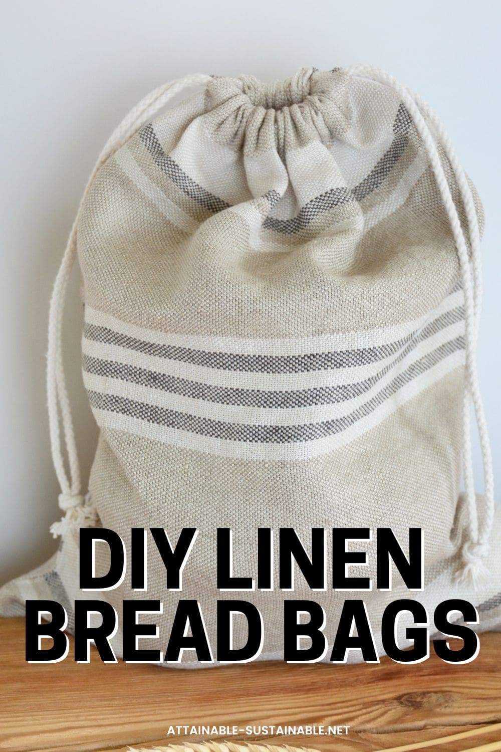 Beige striped linen bread bag standing upright.