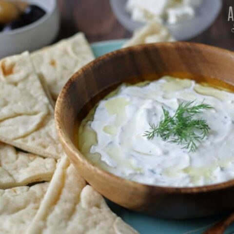 tzatziki in wooden bowl with pita chips