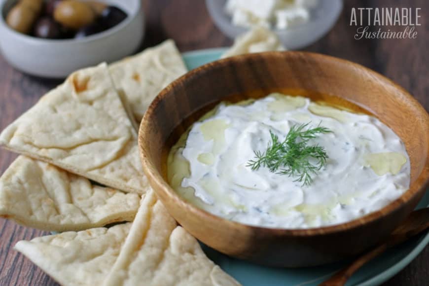 tzatziki in wooden bowl with pita chips