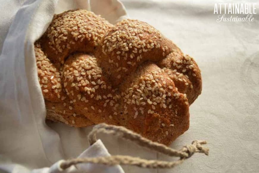 loaf of braided bread in a linen bread bag from above