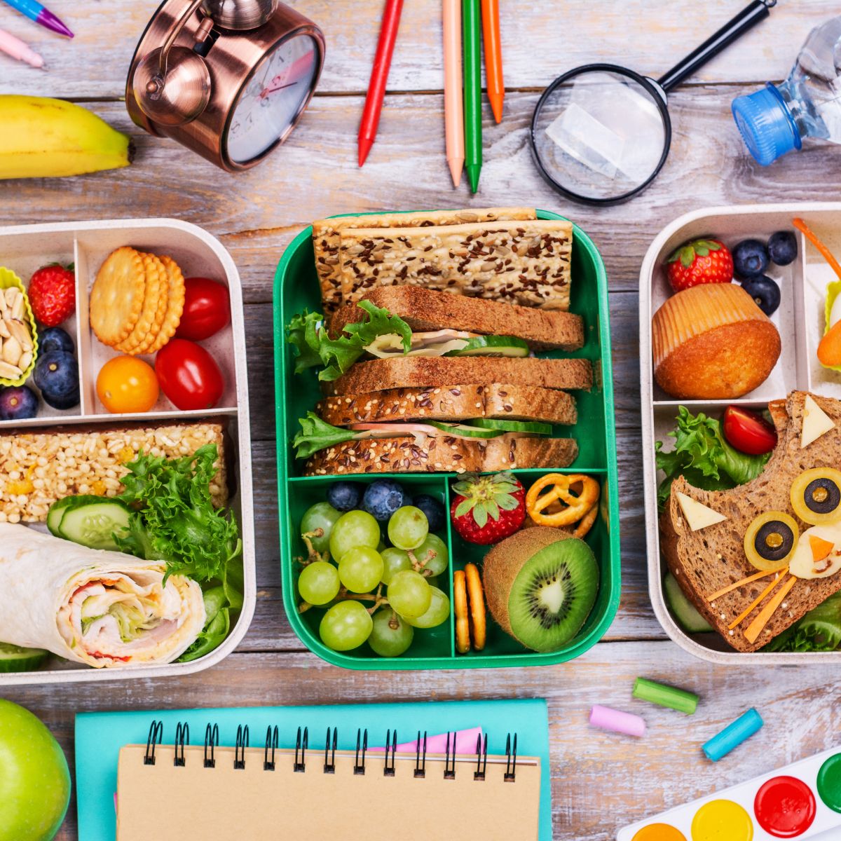 several reusable boxes packed with healthy lunch options.