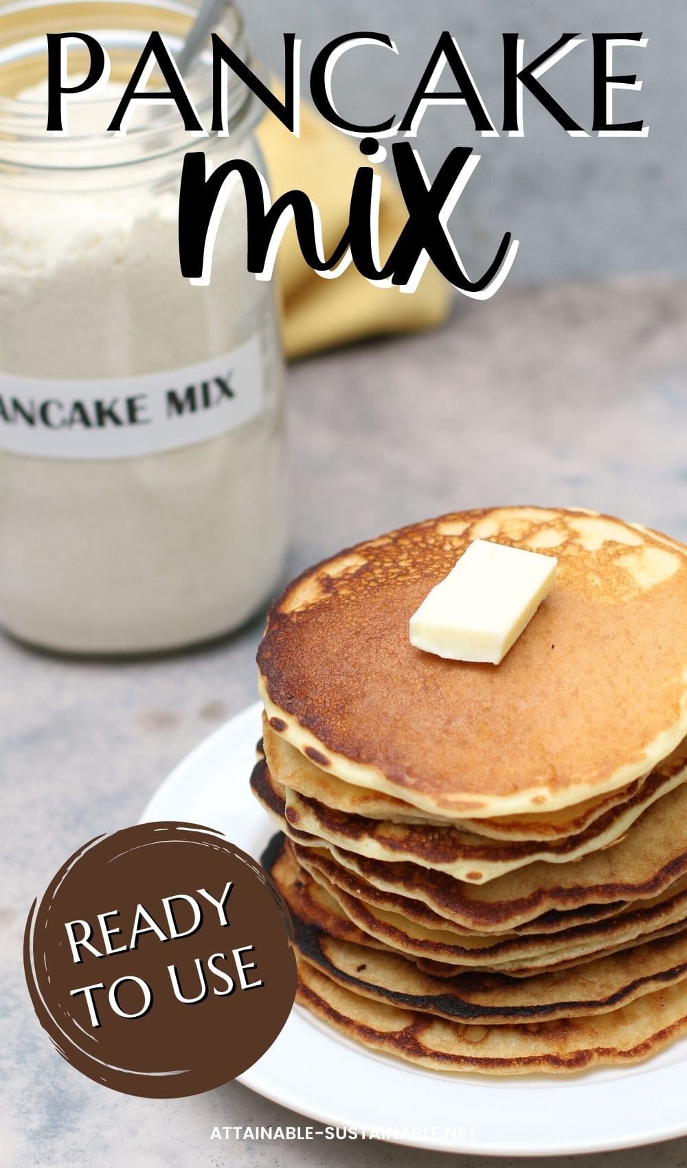 pancakes in a stack on a white plate with a pat of butter