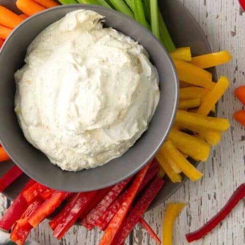 french onion dip in a bowl with fresh veggies