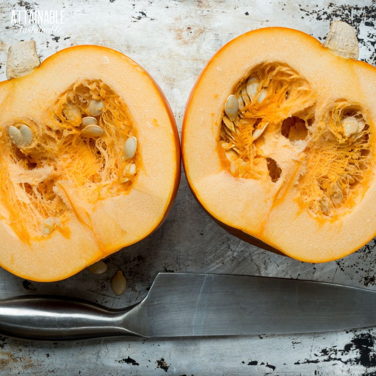 two pumpkin halves on a baking tray.