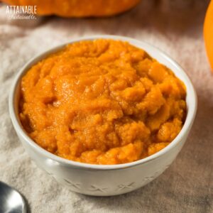 white bowl full of orange pumpkin puree.