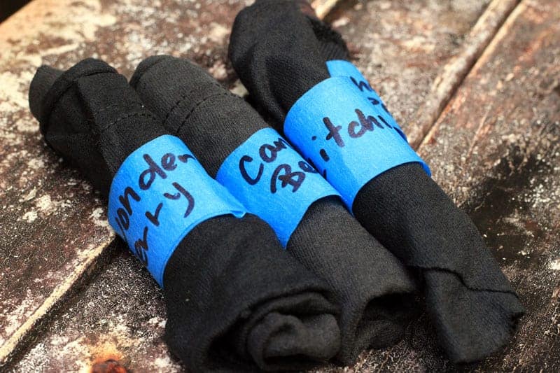 rolled up black fabric with blue tape -- presprouting before planting seeds