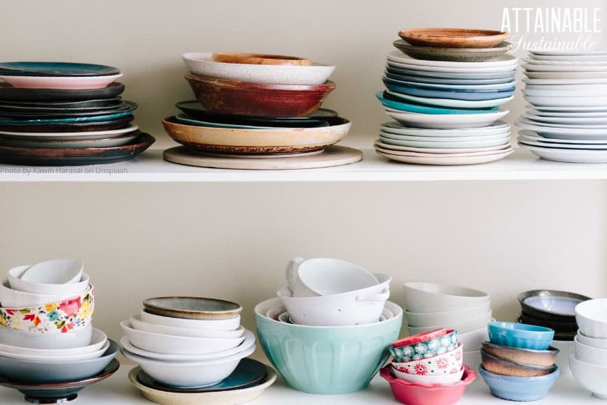 two shelves full of brightly colored stacked plates, assorted colors