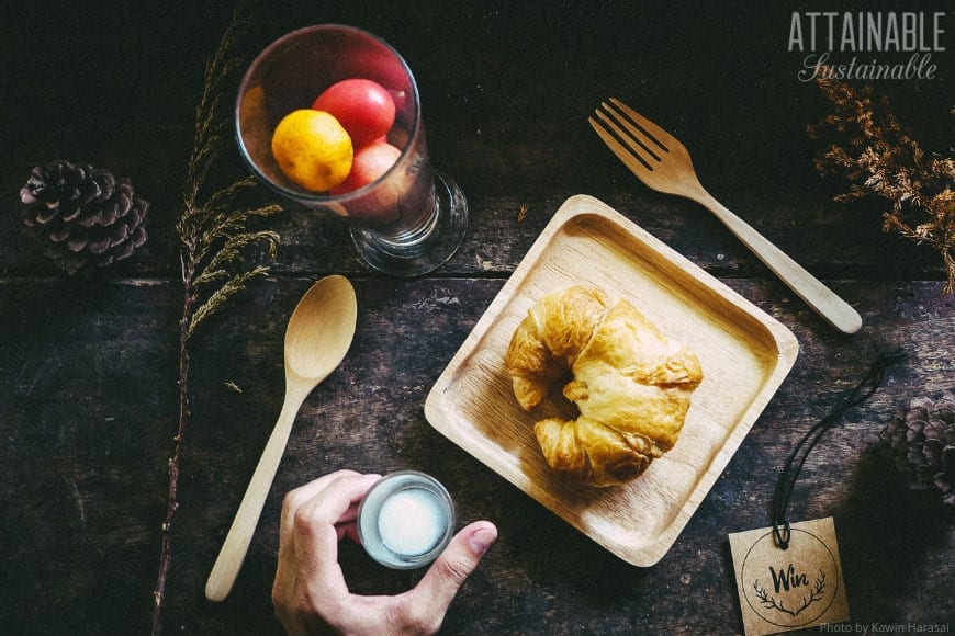 croissant on a bamboo plate, dark background