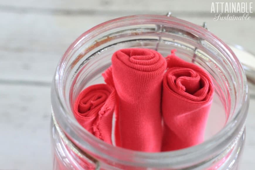 homemade dryer sheets (pink) in a glass jar 