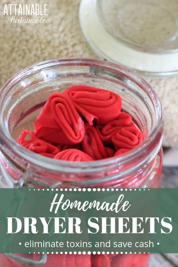 homemade dryer sheets (pink) in a glass jar with a tan towel behind