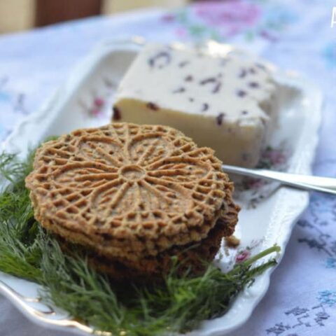 pizzelle recipe made and plated on a floral plate with cheese