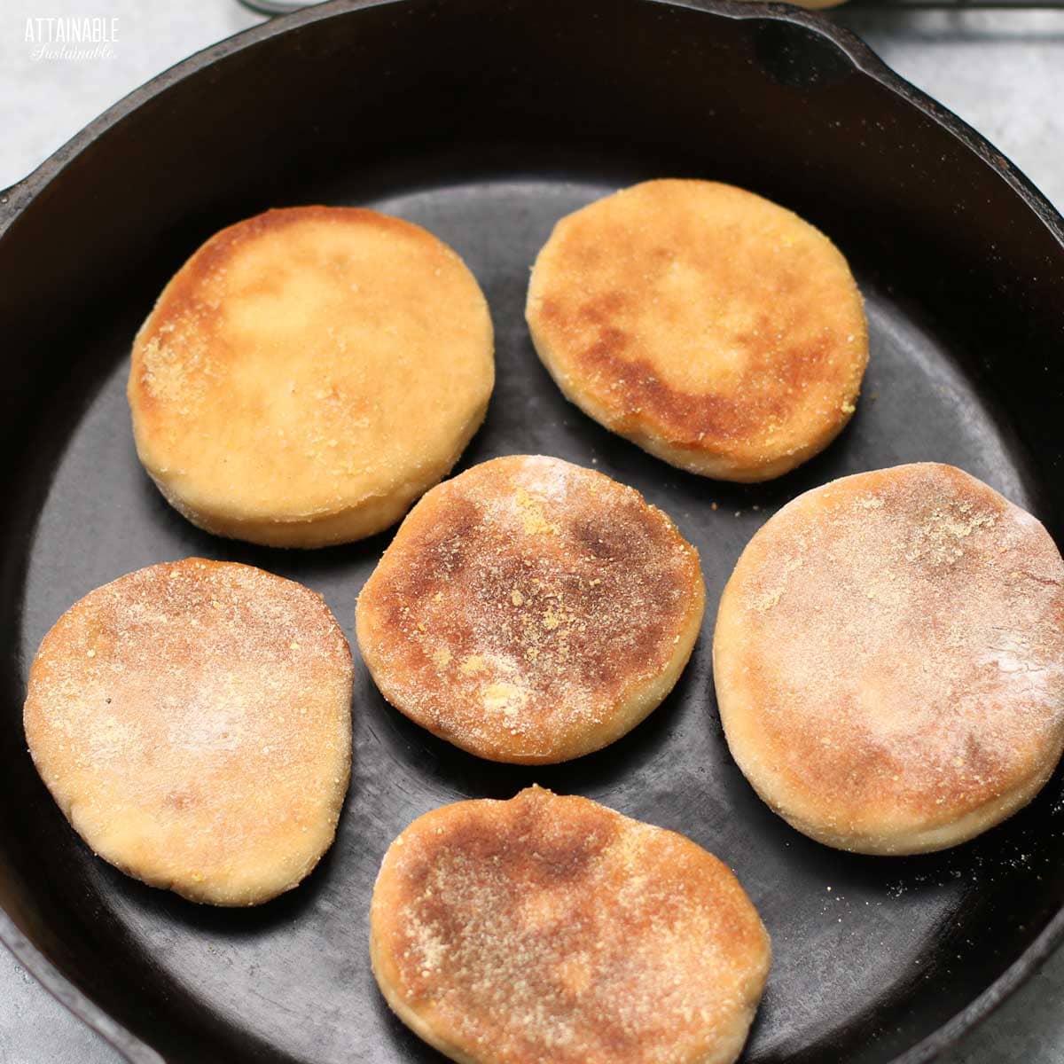 browned english muffins in a cast iron skillet.
