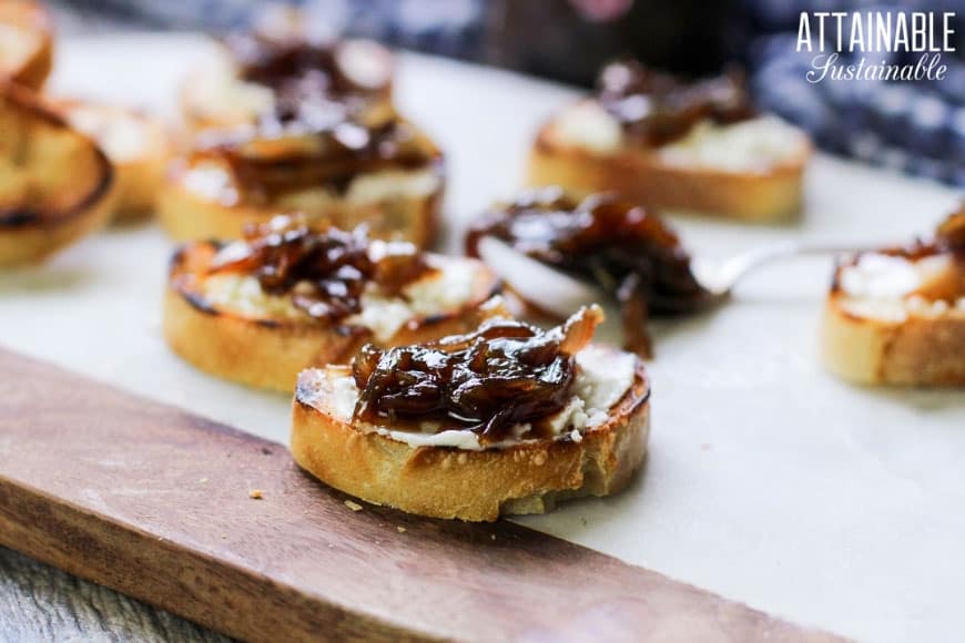 toasted baguette slices spread with goat cheese and balsamic onion jam