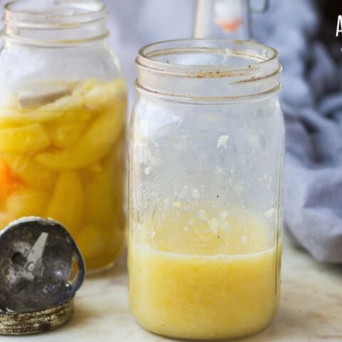 fermented banana peppers in a glass jar, hot sauce in a glass jar