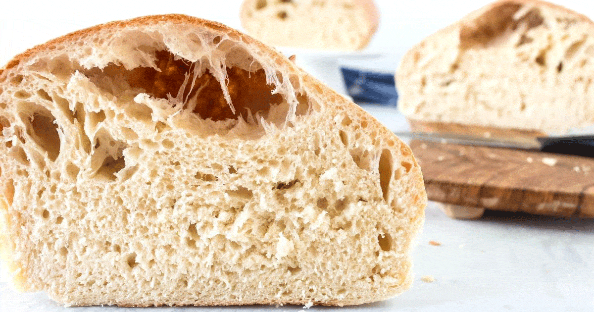sliced end of boule bread with big airy hole