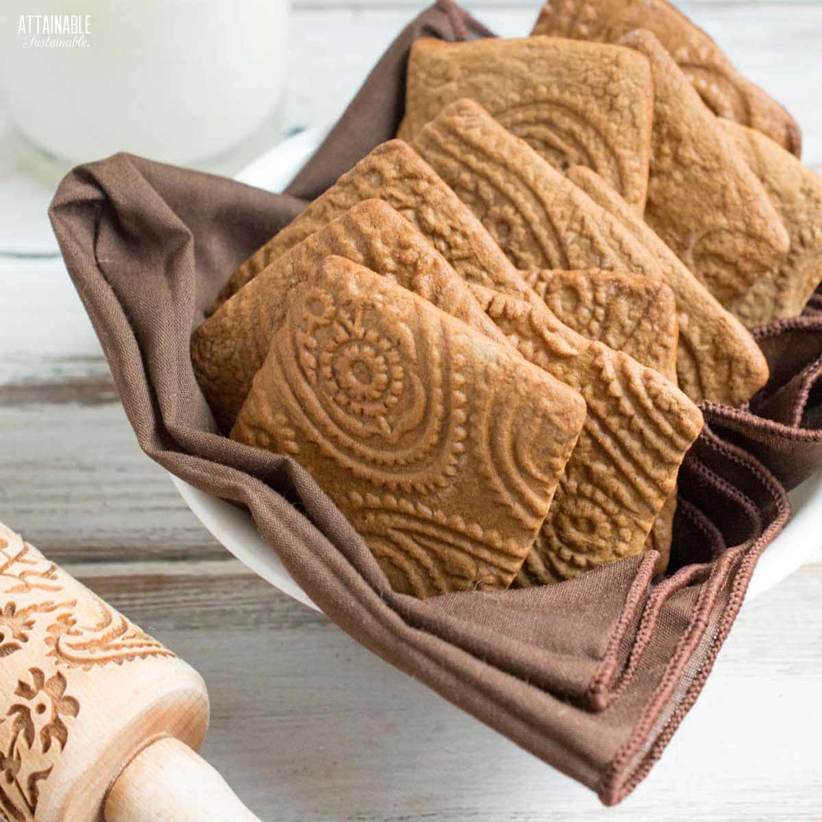 cookies in a basket lined with brown linen.