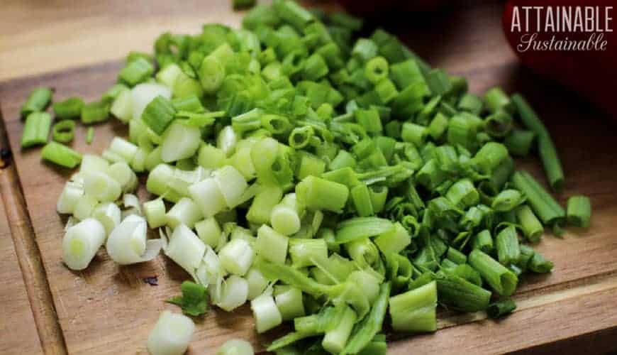 chopped green onions on wooden cutting board