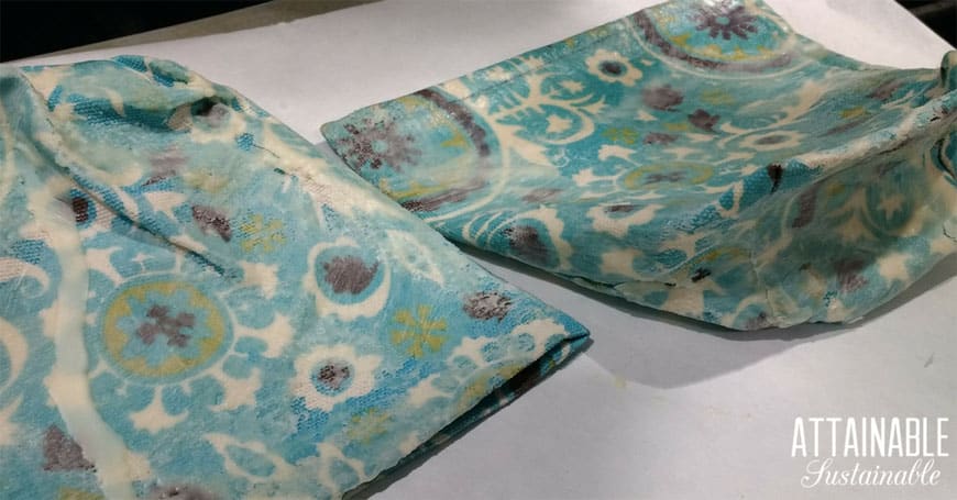making reusable snack bags with teal fabric - covering them with beeswax mixture
