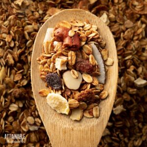 wooden spoon with toasted granola ingredients.