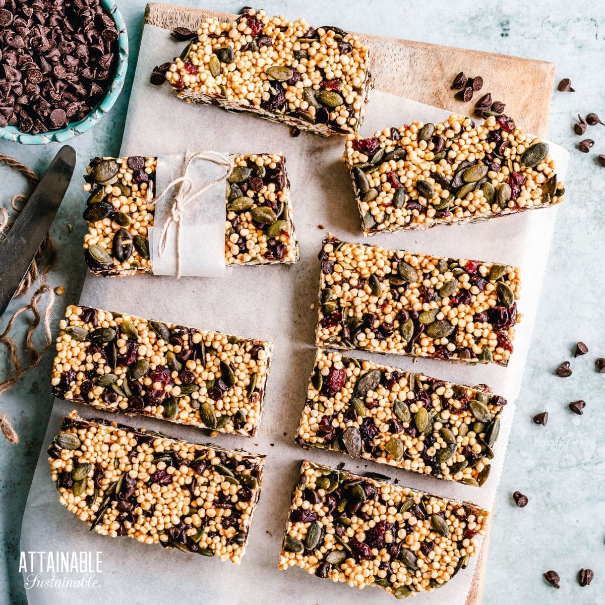 granola bars on a cutting board covered in parchment paper.