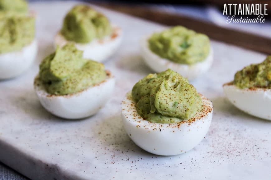 close up of deviled eggs with green filling