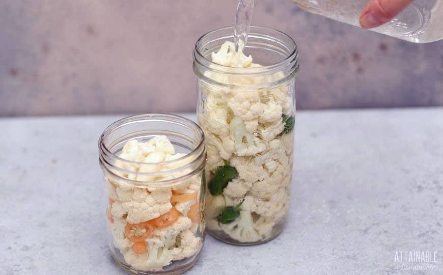 pouring water into fermentation jars