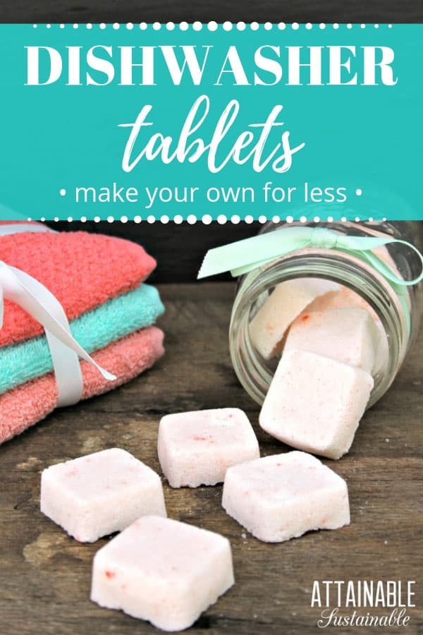 homemade dishwasher soap tablets on a piece of wood, with peach and teal dish cloths in background.