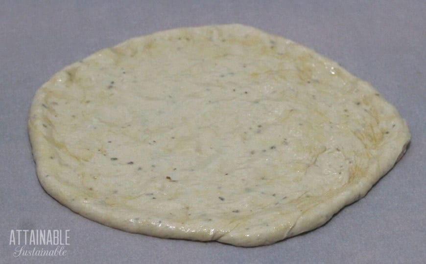 raw pizza dough round.