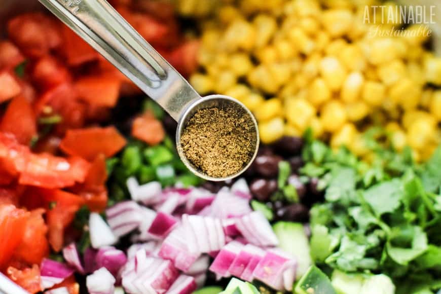 This flavorful corn and black bean salsa looks beautiful on a buffet table & it's super easy to make. This homemade black bean dip is budget friendly, too. ingredients for corn and black bean salsa separated by color